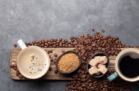 Coffee cups, sugar and roasted beans on dark stone table. Top view with copy space. Flat layの写真素材
