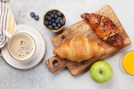 Breakfast with coffee, orange juice and croissant. Top view on stone table. Flat layの写真素材