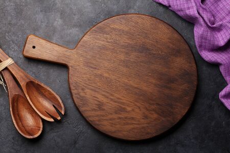 Kitchen table with utensils, cutting board and tablecloth and space for your recipe or menu. Top view flat layの写真素材
