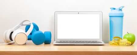 Healthy lifestyle, fitness, sport and online technology concept. Laptop and workout equipment. With copy space for your text or appの写真素材