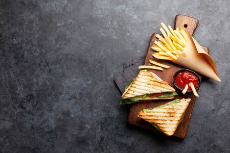 Club sandwich, potato fries chips and sauce. Fast food take away. Top view with copy space