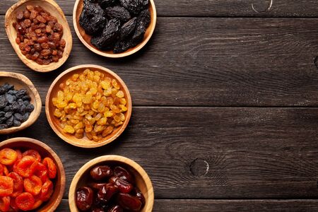 Various dried fruits on a dark wooden table. Top view flat lay with copy spaceの写真素材