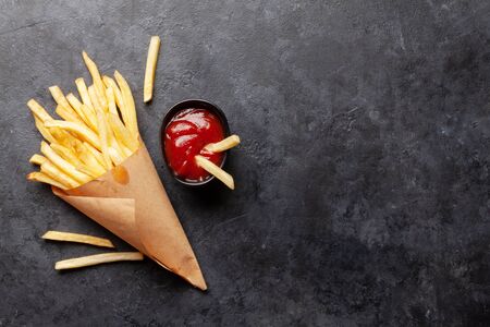 Potato fries chips and tomato sauce. Fast food take away. Top view with copy space