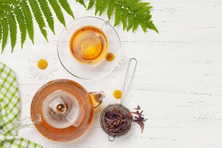 Herbal tea in teapot and cup on wooden table. Top view with copy space. Flat layの写真素材
