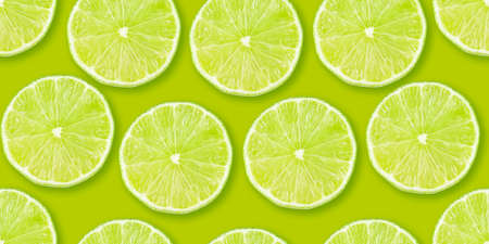Lime citrus slices seamless backdrop texture. Flat lay backdrop