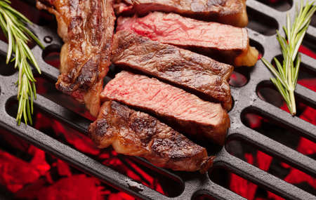 T-bone beef steak cooking on grill. Top view closeupの写真素材