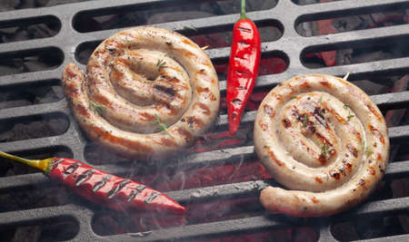 Hot spicy grilled sausages on coal grillの写真素材
