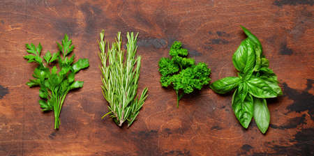 Various garden herbs on wooden table. Top view flat layの写真素材