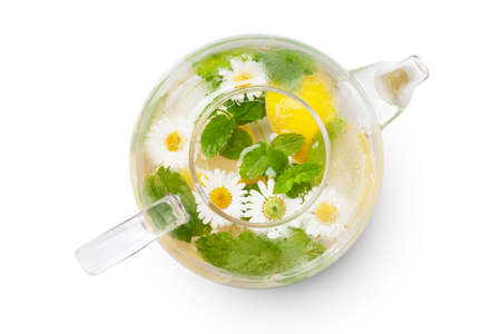 Green herbal tea pot with mint and chamomile. Isolated on white background. Top view flat layの写真素材
