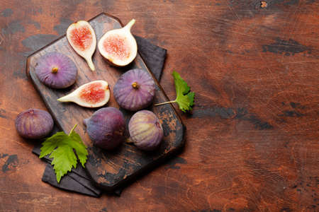 Ripe sweet figs on cutting board. Top view with copy spaceの写真素材