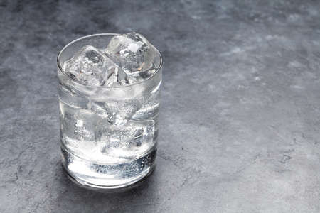 Glass of water with ice cubes. With copy space