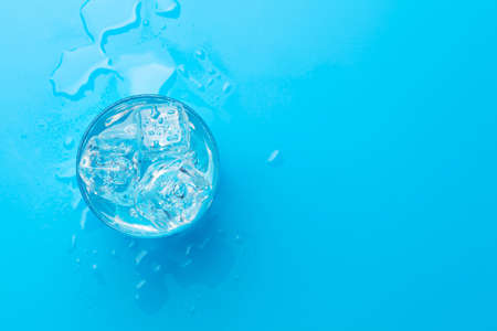 Glass of water with ice cubes. Top view flat lay With copy spaceの写真素材