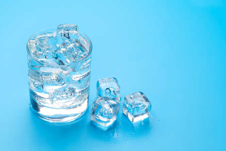Glass of water with ice cubes. With copy spaceの写真素材