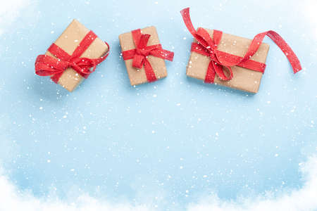Christmas gift boxes over blue background with space for your greetings. Top view flat lay