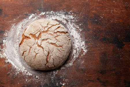 Homemade baked bread on wooden table. Top view flat lay with copy space