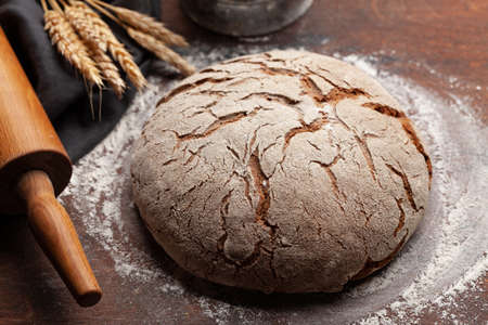Homemade baked bread on wooden table