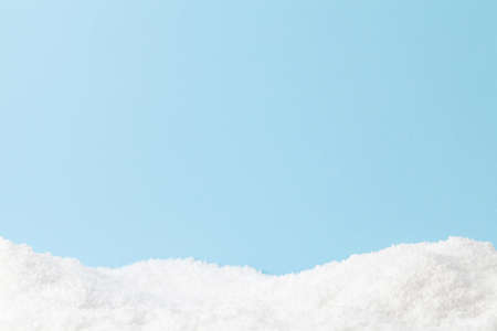 Christmas greeting card with snow over blue background and copy space for your xmas greetingsの写真素材