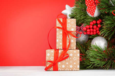 Christmas greeting card with decorater fir tree and gift boxes for your xmas greetingsの写真素材