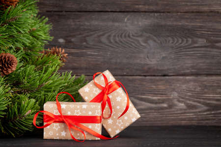 Christmas greeting card with fir tree, gift boxes and space for your xmas greetingsの写真素材