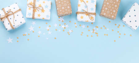 Christmas gift boxes over blue background with space for your greetings. Top view flat layの写真素材