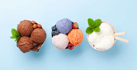 Berry, vanilla and chocolate ice cream scoopes. Top view flat layの写真素材