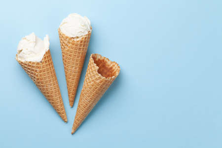 Homemade vanilla ice cream sundae and waffle cones. Top view flat lay with copy space