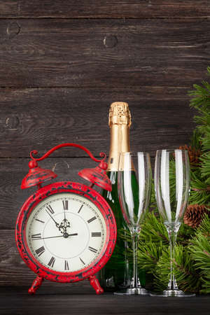 Christmas greeting card with fir tree, alarm clock, champagne and space for your xmas greetingsの写真素材