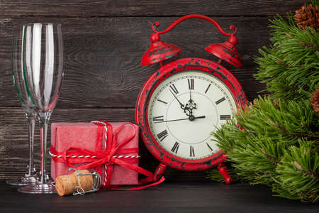 Christmas greeting card with fir tree, alarm clock, champagne, gift boxの写真素材