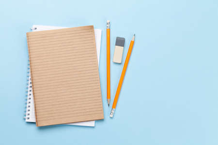 Business desk workplace and office objects over blue backdrop. Top view flat lay with copy space for your textの写真素材