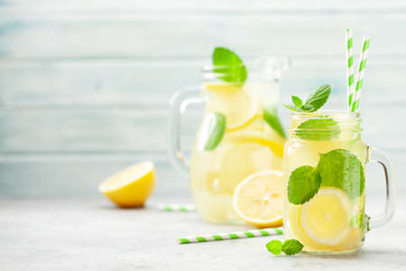 Mason jar and jug with lemon and mint homemade lemonade. With copy spaceの写真素材