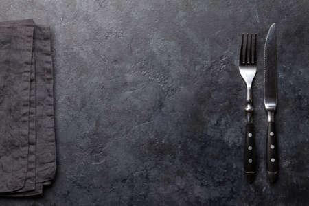 Stone table with knife and fork. Top view flat lay with copy spaceの写真素材