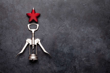 Christmas greeting card with fir tree shaped corkscrew and star decor. Top view flat lay with space...