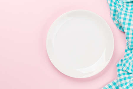 Empty plate on pink background. Top view flat lay with copy spaceの写真素材