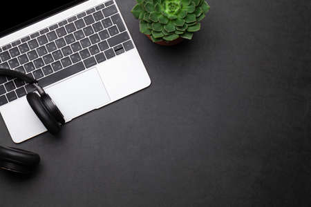 Business desk workplace and office objects over black leather backdrop. Top view flat lay with copy...