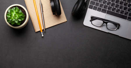 Business desk workplace and office objects over black leather backdrop. Top view flat lay with copy...