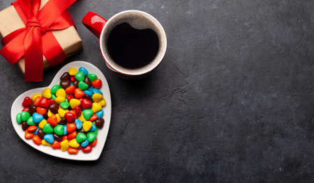Heart shaped candies, coffee and gift box. Valentines day card. Top view flat lay with space for your greetingsの写真素材