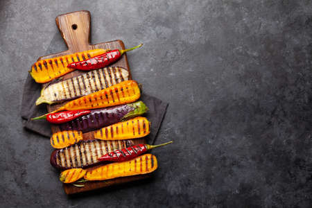 Grilled vegetables on cutting board with spices and herbs. Top view flat lay with copy spaceの写真素材