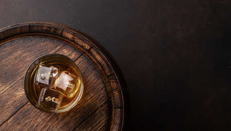 Scotch whiskey glass and old wooden barrel. With copy space. Top view flat layの写真素材