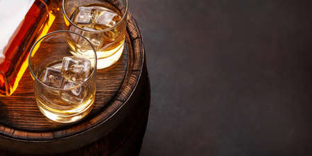 Scotch whiskey bottle, glasses and old wooden barrel. With copy spaceの写真素材