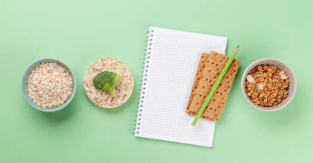 Healthy food and weigh loss concept. Top view flat lay with notepad for your fitness or diet planの写真素材