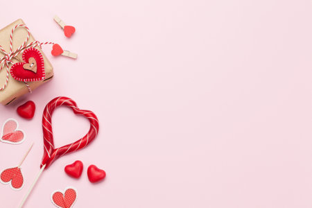 Valentines day greeting card with gift box and candy over pink background with copy space for your greetings. Top view flat layの写真素材