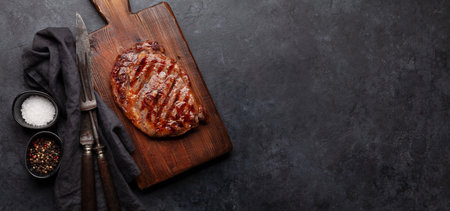 Grilled beef steak with spices. On cutting board. Top view flat lay with copy spaceの写真素材