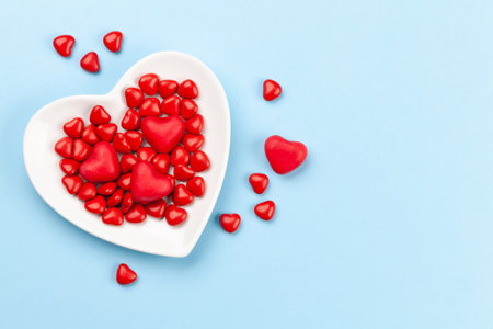 Valentines day with candy hearts over blue background with copy space. Top view flat layの写真素材