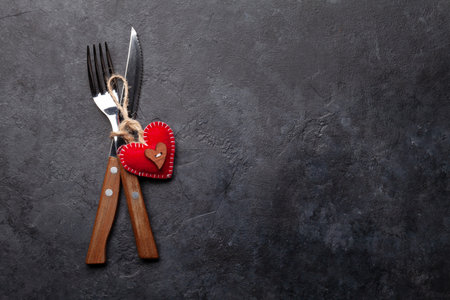 Valentines day table with silverware and heart decor. Top view flat lay with copy spaceの写真素材