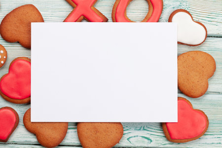 Valentines day greeting card over gingerbread cookies. Top view flat lay with copy spaceの写真素材