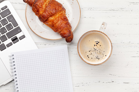Office desk with supplies, coffee and laptop. Remote office and work from home concept. Top view flat lay with copy spaceの写真素材