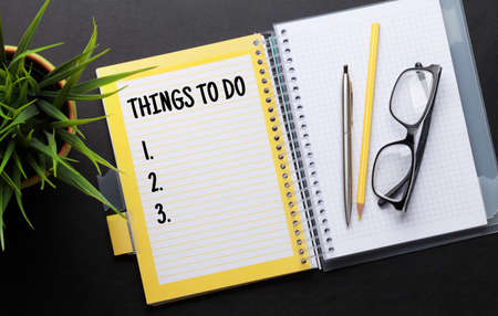 Office desk with to do list notepad and supplies. Top view flat layの写真素材