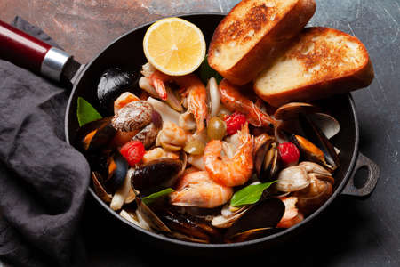 Mixed grilled seafood. Various roasted shrimps, mussels and shellfish in frying panの写真素材