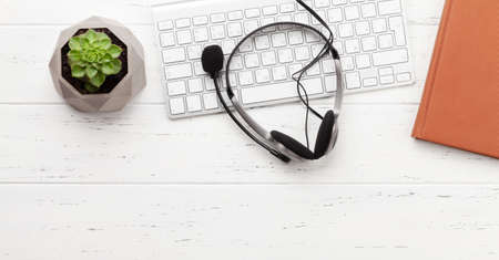 Office desk with headset and supplies. Remote office and work from home concept. Top view flat lay with copy spaceの写真素材