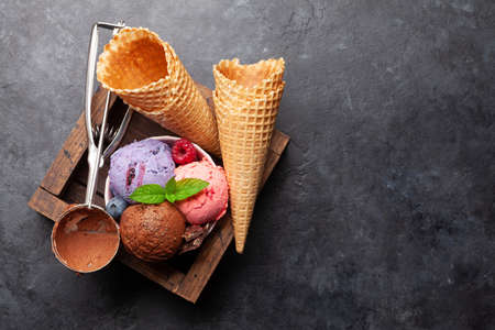 Berry, vanilla and chocolate ice cream sundae. Top view flat lay with copy space